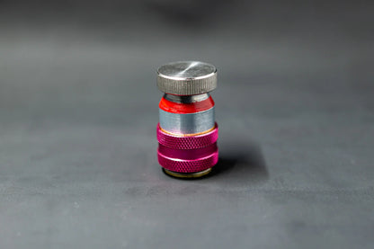 AC service valve cap with red and silver metal parts for car air conditioning repair